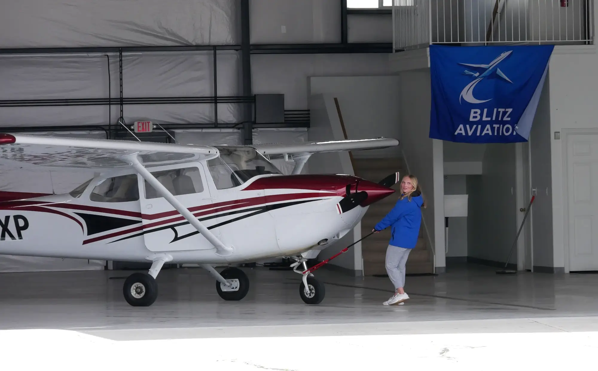 Student pulling Cessna out of the hangar at Blitz Aviation