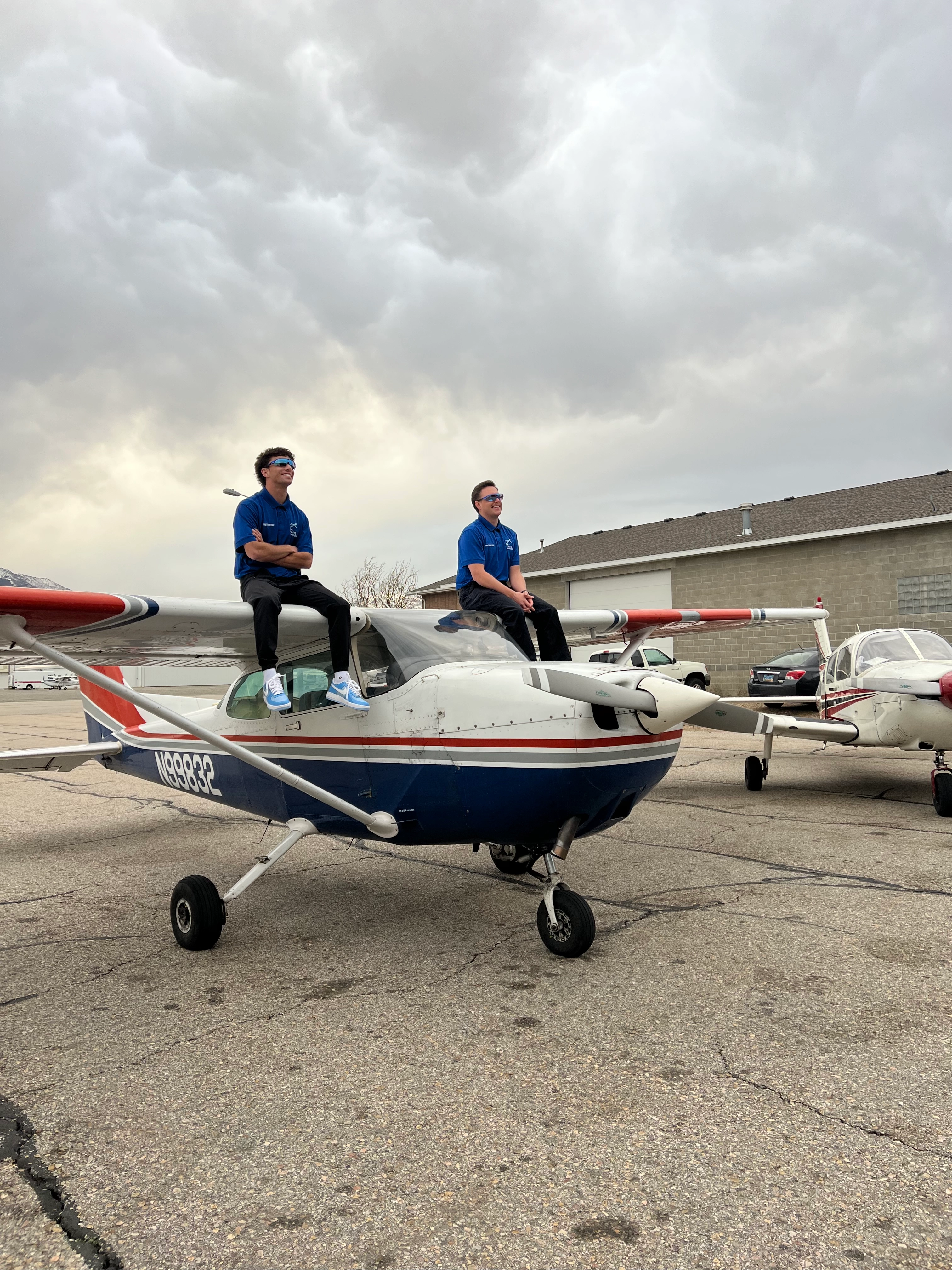 Blitz Aviation Ogden Utah flight school pilot training - Two CFIs standing on top of plane wings