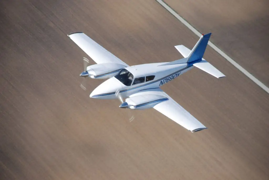 Top view of Piper PA-30 Twin Comanche in flight