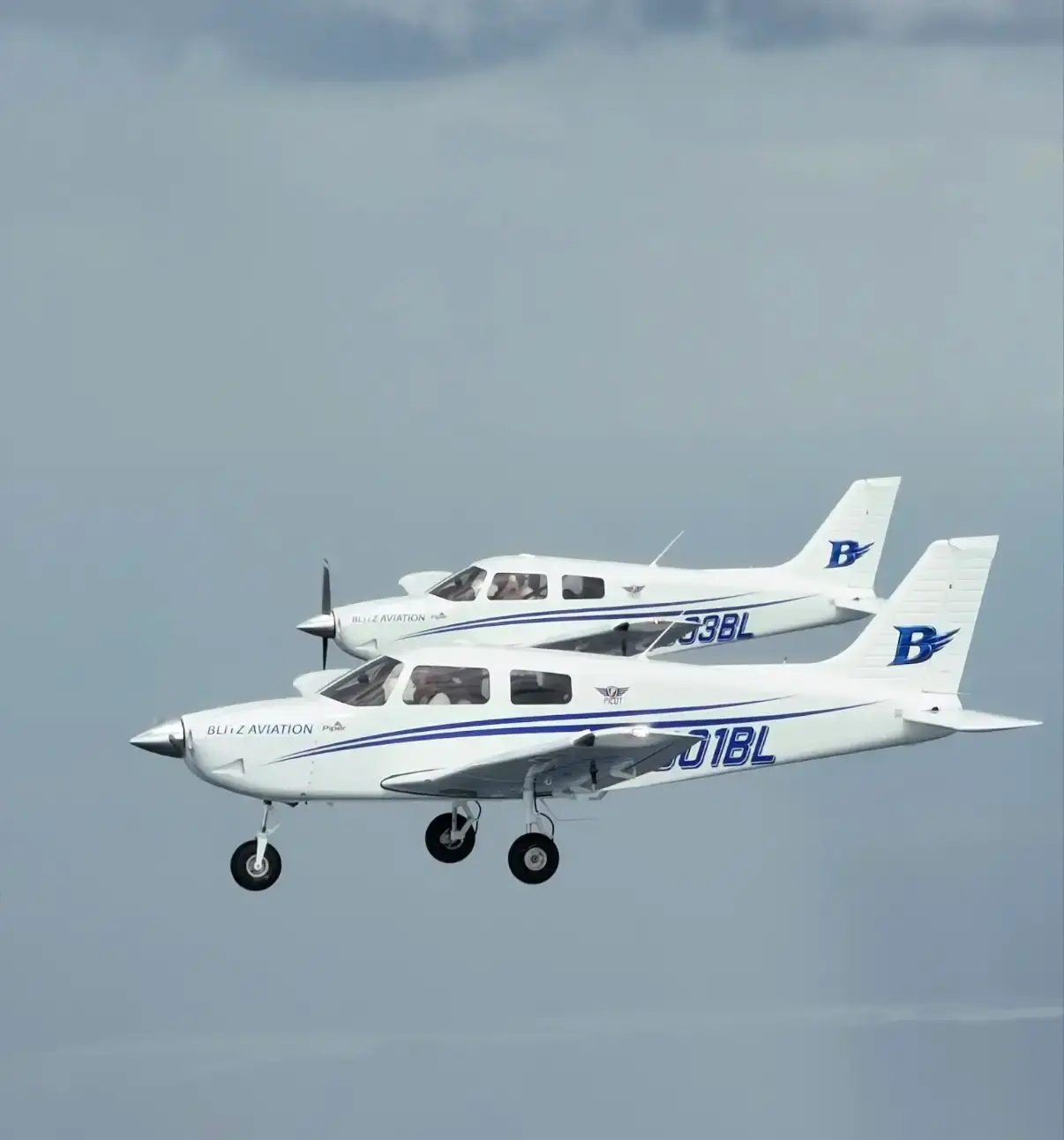 Two Blitz Aviation Piper Pilot 100i training aircraft flying in formation