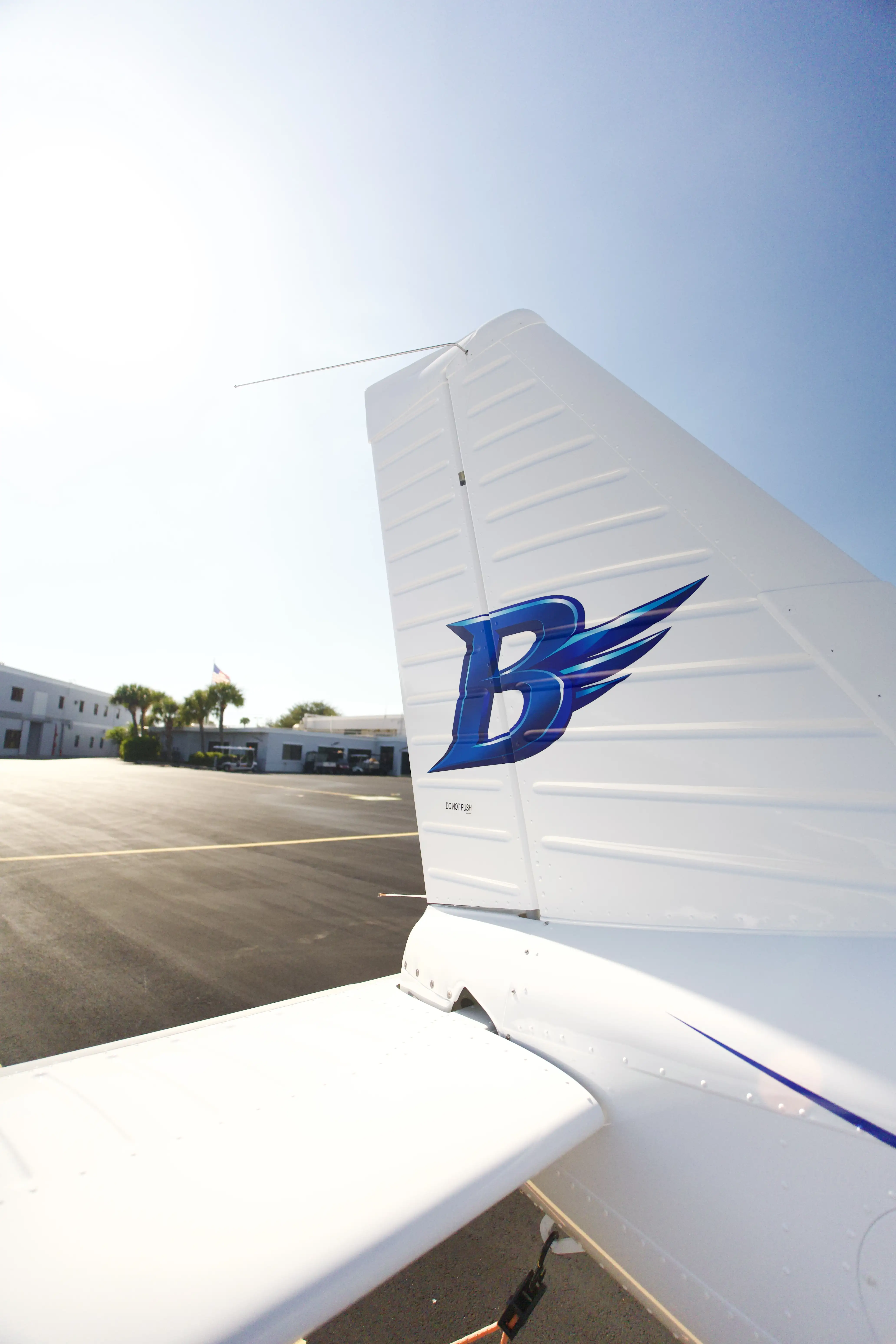 Two Blitz Aviation Piper Pilot 100i airplanes flying in formation with the winged B logo on their tails