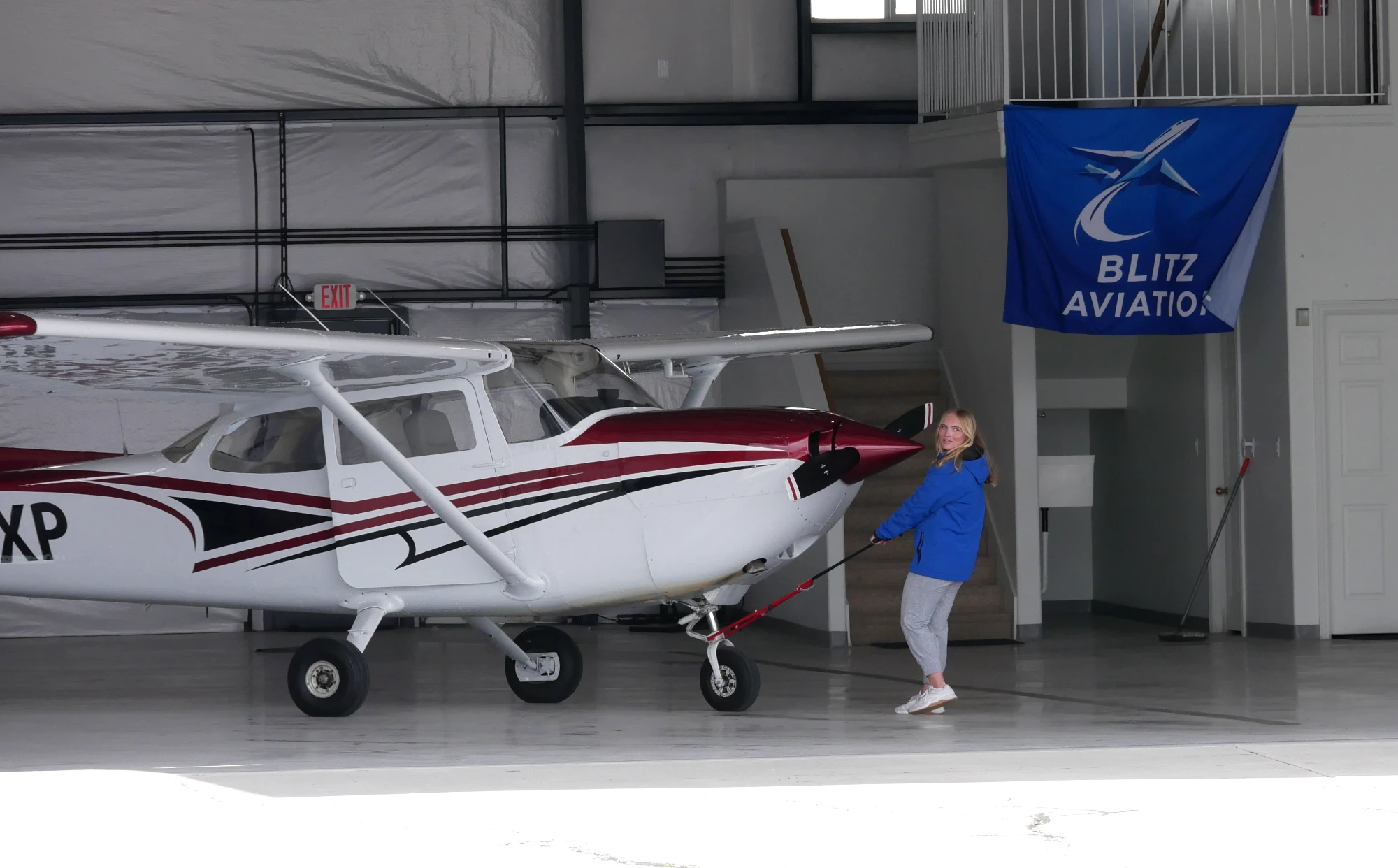 Female pilot pulling a Cessna out of the hangar at Blitz Aviation for a discovery flight in Utah